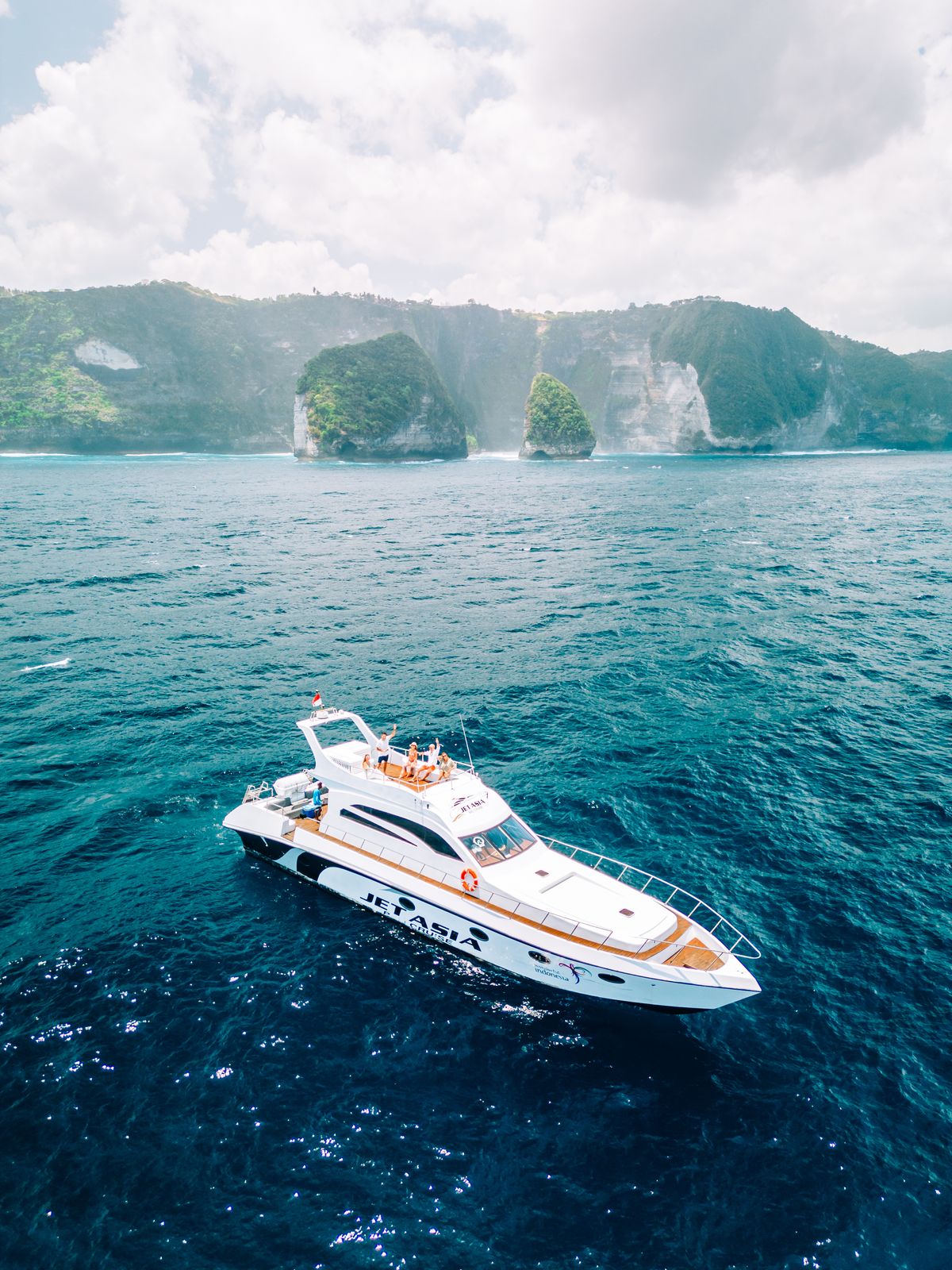 Jet Asia luxury yacht cruising near Nusa Penida cliffs in Bali