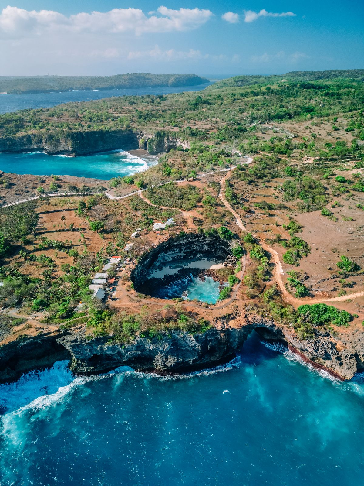 Aerial view of Nusa Penida coastline from a private yacht charter