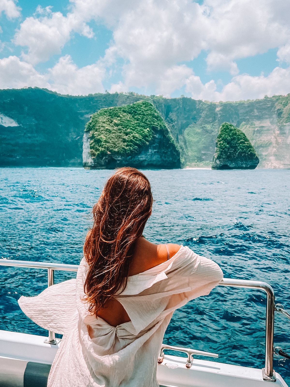 Guest enjoying island views from the yacht bow