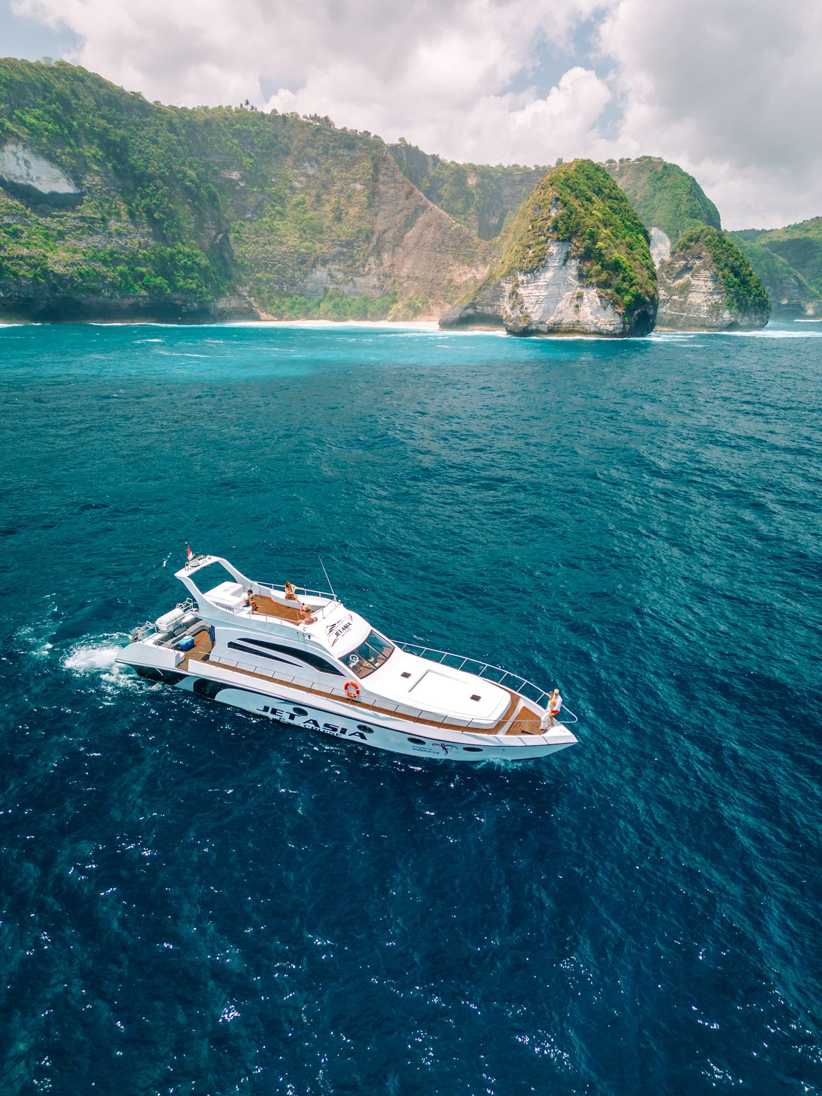 Private yacht anchored by Nusa Penida cliffs